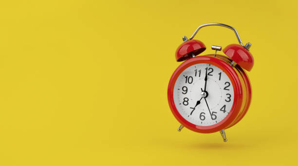 istock Red alarm clock hangs in the air on yellow background 1491027066