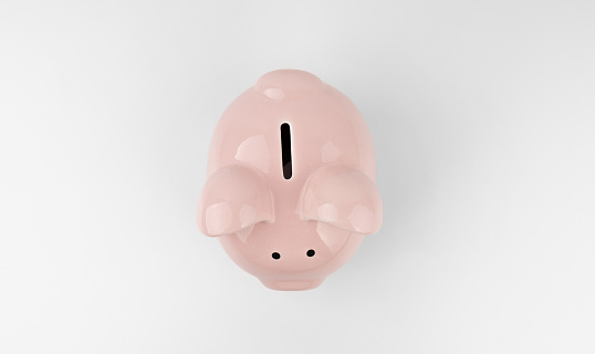 Top view of pink pink piggy bank on a white background