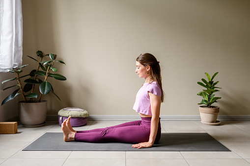 Professional woman practicing yoga at home: Staff, Dandasana