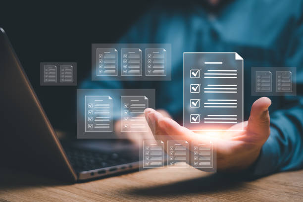 istock Document control and management concept, Businessman review procedures through the use of laptops and show digital checklist documents in hand technology on digital document paperless operation 1491029797