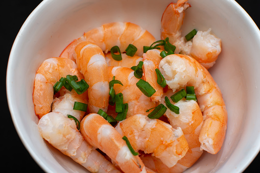 Peeled shrimp with herbs on a plate