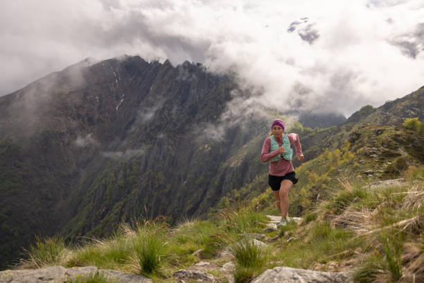 istock Young woman bounds along a mountain ridge 1491032984