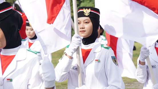 Kediri, East Java, Indonesia - May 12th, 2023 : Indonesian flag raiser on kirab kebangsaan (National carnival)