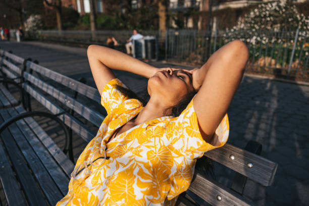 Woman with hands in the head, desperate on a park bench