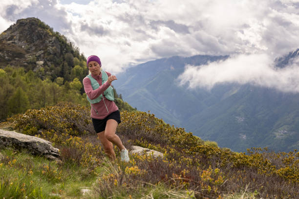 istock Female trail runner follows trail along mountain ridge 1491034328