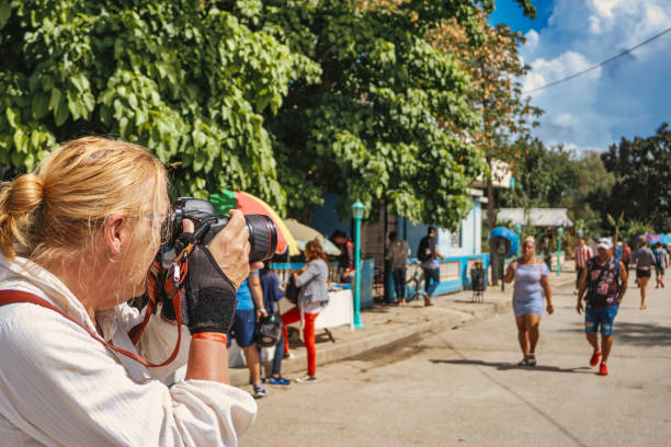 While  visiting  Rafael Freyre municipality, which was called Santa Lucia until 1960,  a senior woman photographer is shooting a street scene of  the small town.