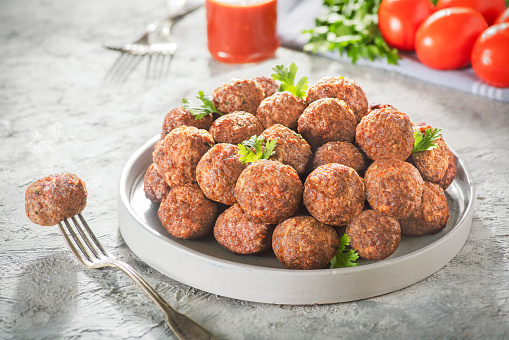 Middle Eastern traditional meatballs served with tomato sauce. Close up with copy space.