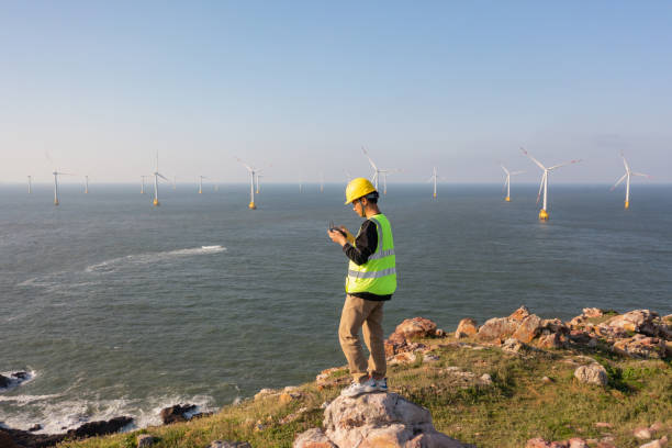 Engineer remote control drone on hill Power engineers use drones to inspect offshore wind farms offshore wind farm stock pictures, royalty-free photos & images