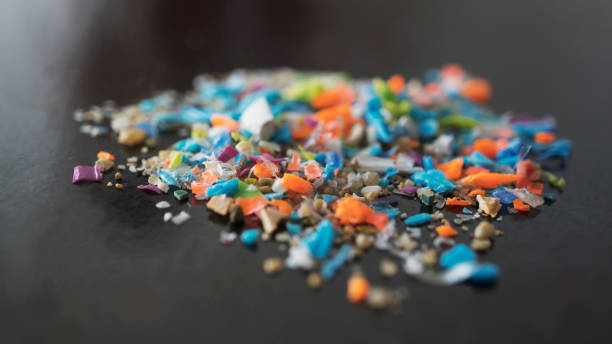 istock Macro shot on a pile of micro plastic particles and sand. 1491039463