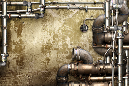 Vintage steampunk backdrop with pipes on stucco wall. Open space with concrete wall and pipelines. Mockup template. Copy space for text. Grunge interior retro background