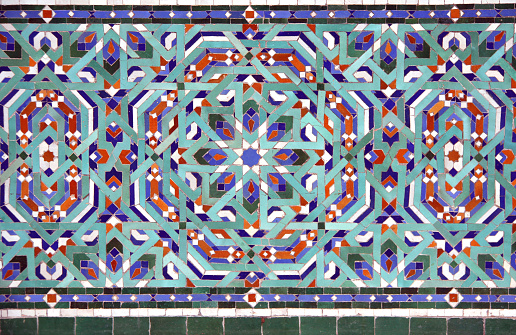 Detail of ancient mosaic wall with geometric ornaments. Horizontal or vertical background with traditional moroccan tile decoration