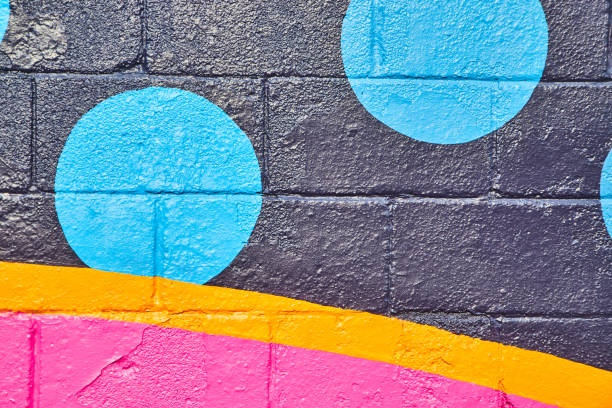 istock Painted cement wall with black, orange, and pink and blue circles 1491041692