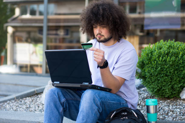 istock Man using laptop and credit card for online shopping 1491043774