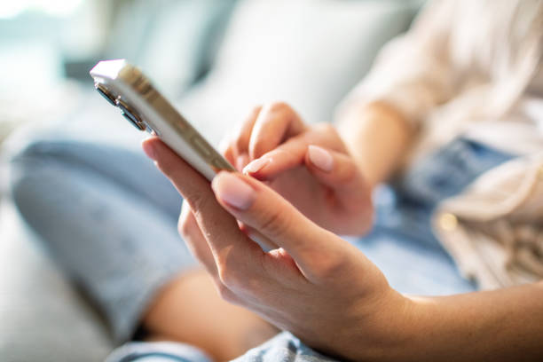 istock Young woman using a smart phone at home 1491044008