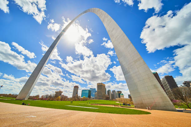 istock Skyline viewed under St. Louis Gateway Arch with vibrant sky and sun 1491045514