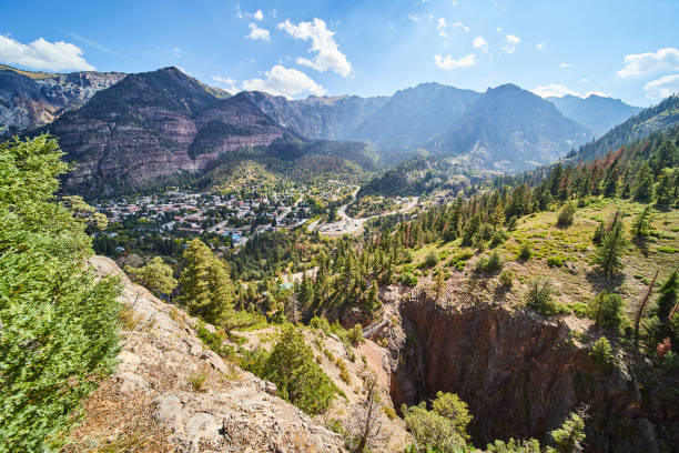 istock Small town surrounded by mountains from overlook above walking bridge and canyon 1491045815