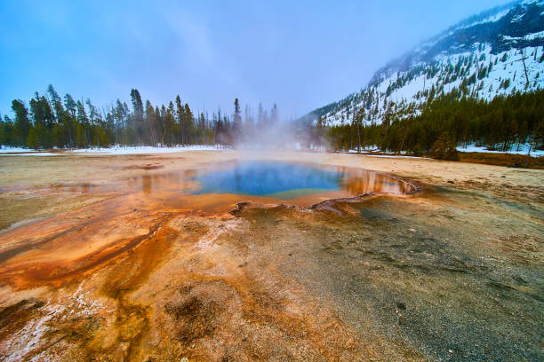 Image of Stunning colorful pools at Yellowstone Biscuit Basin in winter