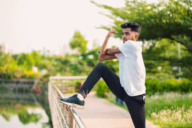 Portrait Of Young Man Jumping Against White Background