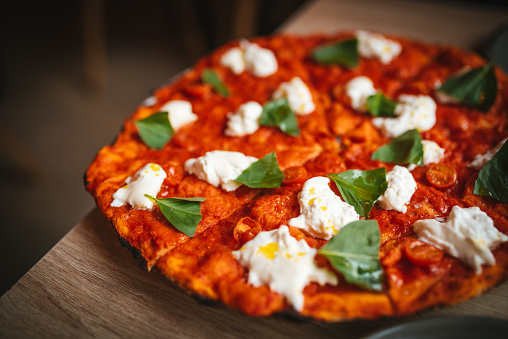 Pizza with burrata cheese and basil