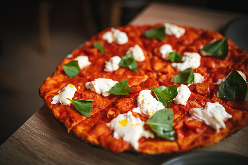 Pizza with burrata cheese and basil
