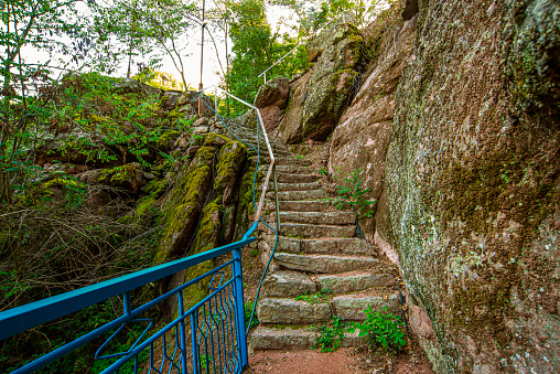 Blue handrail and stone stairs on the mountain hiking route, Old Mountain, Serbia