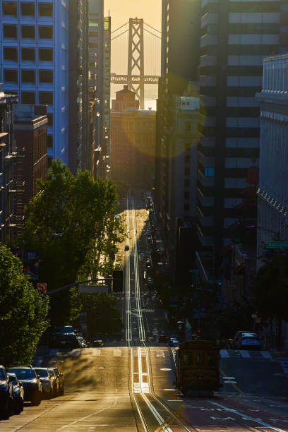 istock Stunning Oakland Bay Bridge between skyscrapers in San Francisco with Trolley 1491047836
