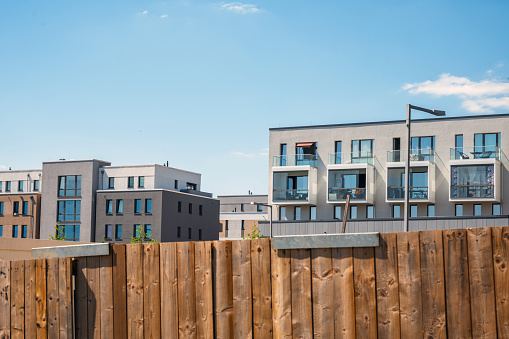 view on modern residential district in the Wasserstadt in Berlin behind wooden fence
