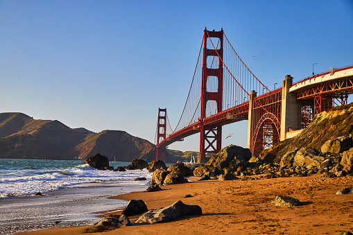 Image of Sunset approaches Golden Gate Bridge from sandy beaches