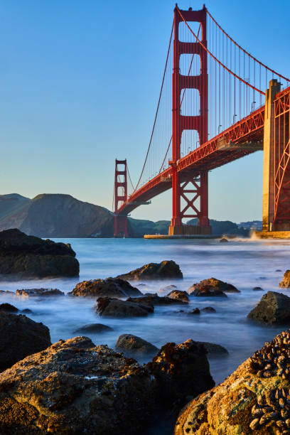 istock Sunset at Golden Gate Bridge on rock-covered beach with mussels 1491048746