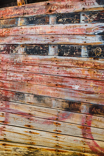 Image of Texture of shipwreck hull with faded red color