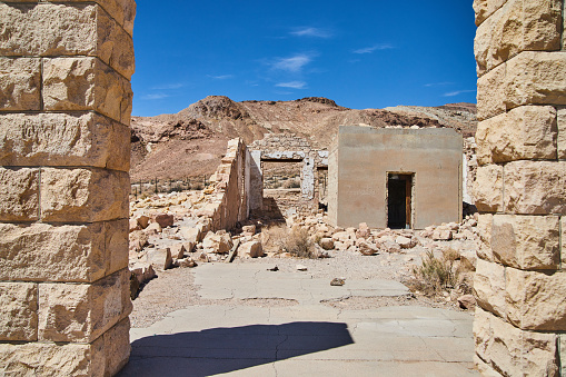 Image of Through entrance of abandoned stone building in ghost town