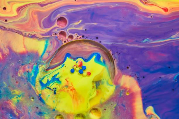 Mystical rainbow of colors on liquid surface with tiny acrylic spheres