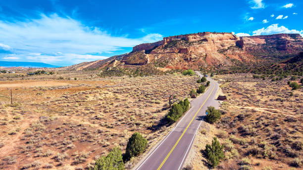 istock Open road across desert into mountains 1491050545