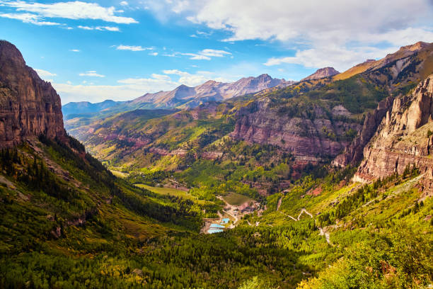 istock Open view of large mountain valley with lush green and yellow fall forest 1491050569