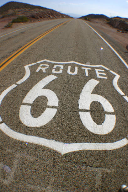istock Paint on the road announces that it is Route 66, which extends into the horizon 1491050844
