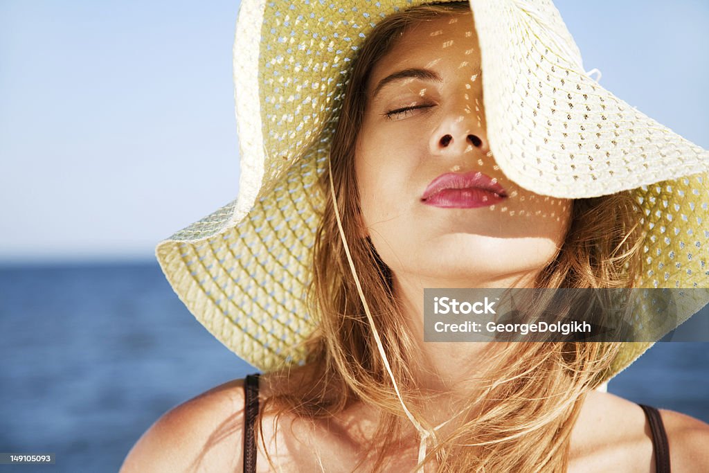 Beautiful woman on a beach Beautiful woman on a beach on a sunny day Human Face Stock Photo