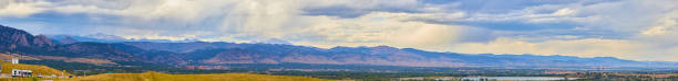 istock Panorama of giant mountain range with rain clouds 1491050965