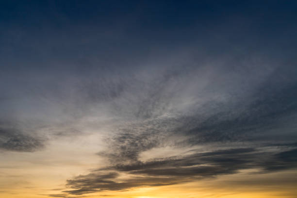 istock Medium veil clouds are overlaid by high veil clouds. The sun is just setting. 1491051038