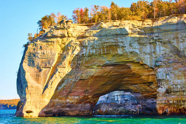 istock Pictured rocks with tunnel through the stone that looks painted 1491051572