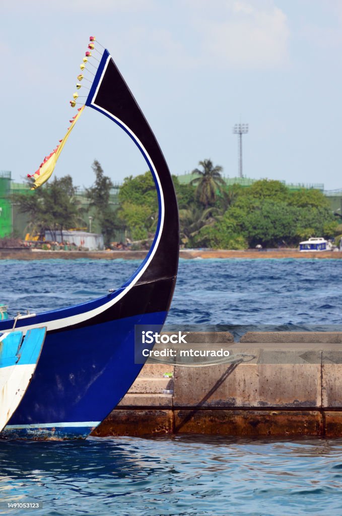 Dhoni bow - traditional boat, Malé, Maldives Malé, Maldives: curved prow with flowers of a dhoni, the traditional boat of the Maldives, they are used as fishing vessels, ferries,  and cargo ships. Archipelago Stock Photo