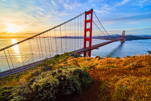 Image of View from trail on cliffs of iconic Golden Gate Bridge at sunrise