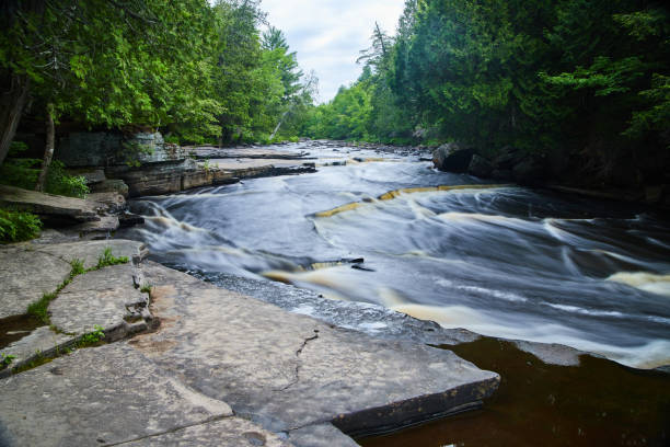 istock View of river with small cascading waterfalls along grey rocks 1491054284