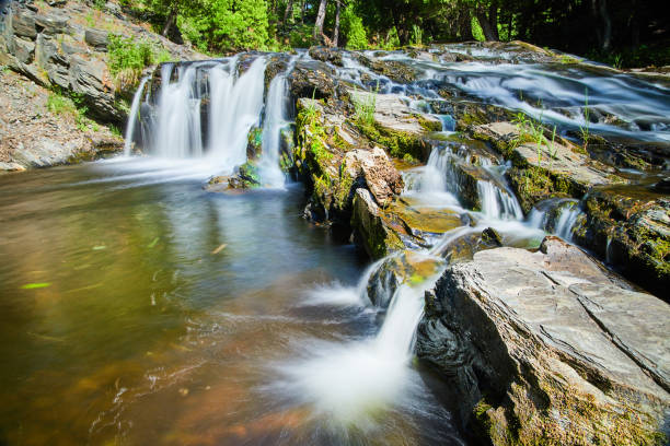 istock Waterfalls pouring over slope of mossy rocks 1491054713