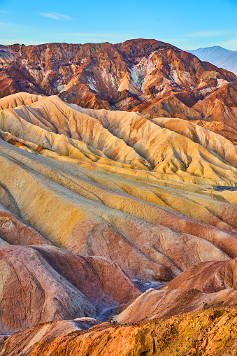 Image of Waves of color from eroded sediment create stunning mountain formations in Death Valley