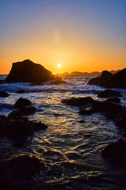istock West coast sunset on beach with boulders 1491054848