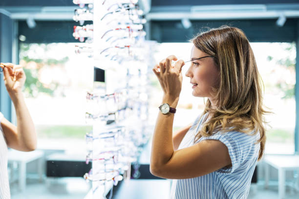 istock Fashionable woman choosing eyeglasses 1491054878