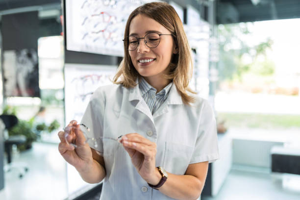 istock Optician looking at the eyewear in optical store 1491054896