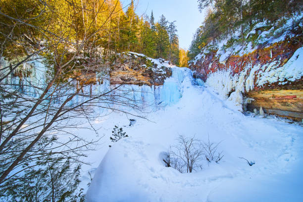 istock Wide view of large frozen waterfall in winter on cliffs 1491055584