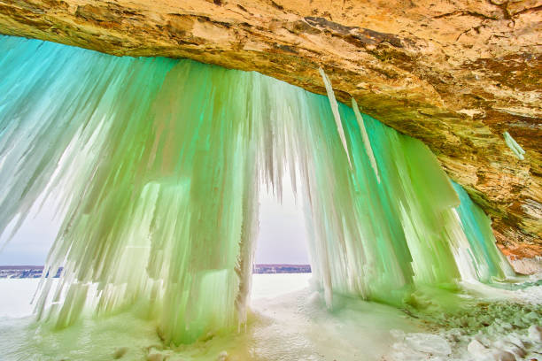 istock Winter ice cavern with tall sheets and icicles of blue and green ice 1491055675