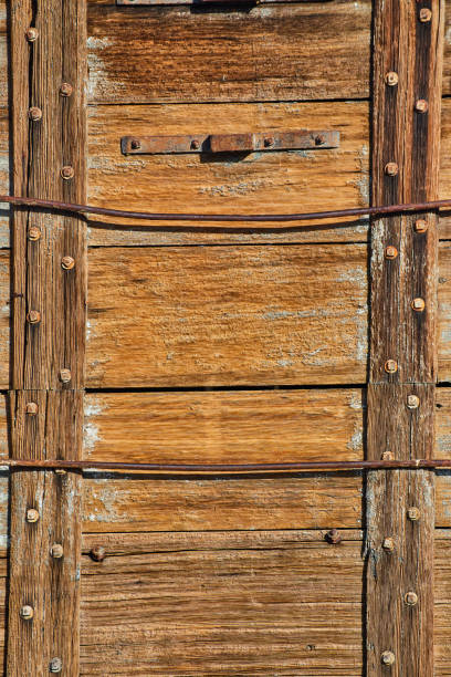 Red planked wall siding with yellow staining from water and wear creates a vibrant background.